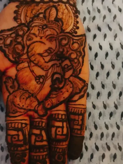 Another close-up of the Ganesha portrait on the palm, showing the fine line work and shading that bring the figure to life.