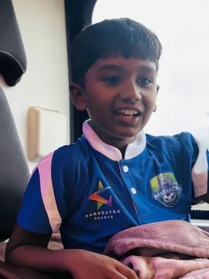 A young player looking excited for the journey to Ahmedabad. These travel experiences are a huge part of their development.