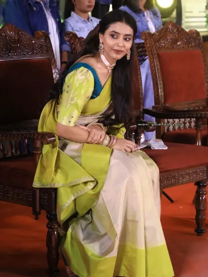 Sapthami Gowda looking stunning in a unique combination of a cream and lime green saree with a puff-sleeve blouse.