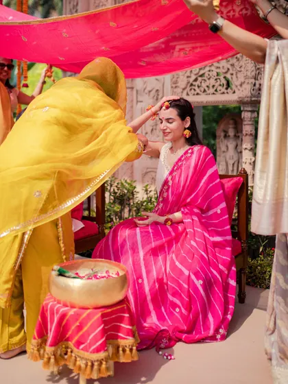 A beautiful moment during the Haldi ceremony, where the bride is blessed by a family member.