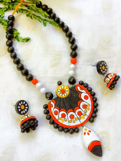 A white and orange version of the fan-design necklace.