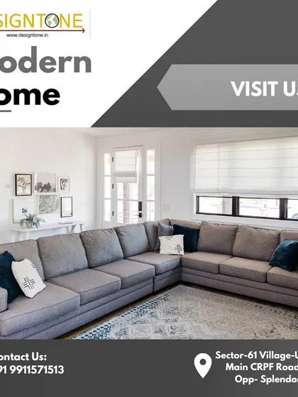An advertisement for our modern home designs, featuring a comfortable grey sectional sofa. Visit our office in Gurgaon to learn more.