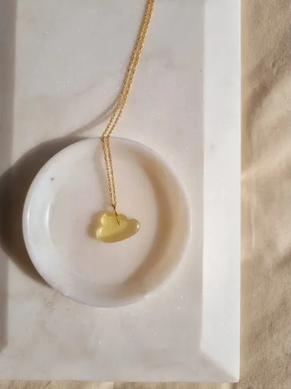 A simple shot of the Lemon Quartz cloud pendant. This stone is excellent for reducing anxiety and improving focus.