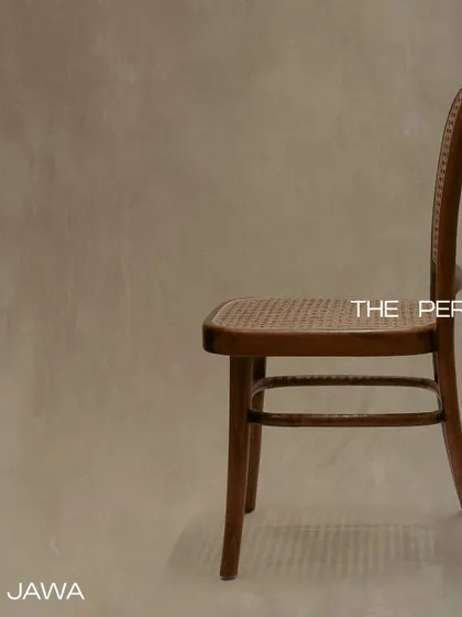 The 'Jawa' chair, a timeless design crafted from premium teak wood with a hand-caned seat and back. Its simple, elegant profile is perfect for dining or as an accent piece.