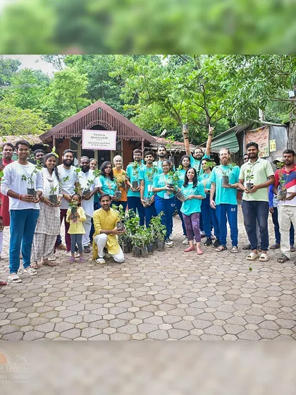 A group of volunteers poses with saplings before a plantation drive. The smiles and camaraderie show that seva is not just work, but a joyful community activity.