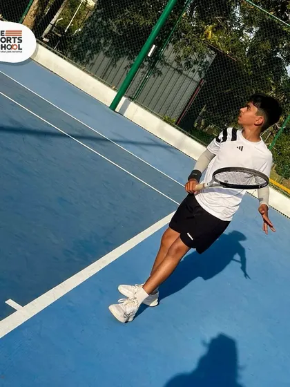 A young tennis player at our summer camp, ready to hit the court and improve his game.