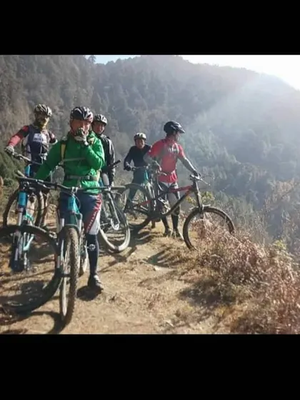 A group of riders taking a break on a high mountain trail in Bhutan. The views and the camaraderie make every climb worth it.