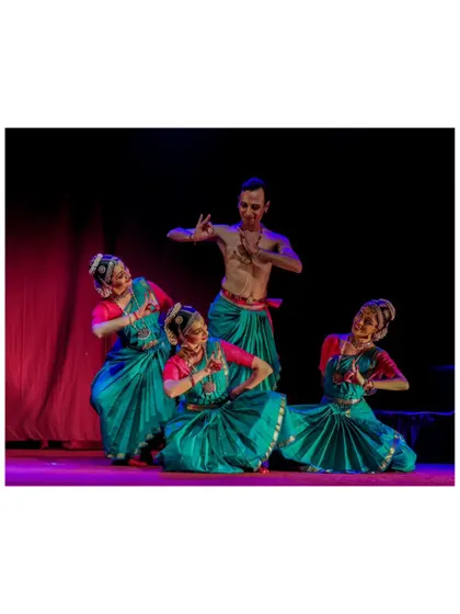 A full ensemble pose from "Tyāgarāja Hṛt Sādana," with three dancers seated and four standing, creating a balanced and visually pleasing stage picture.