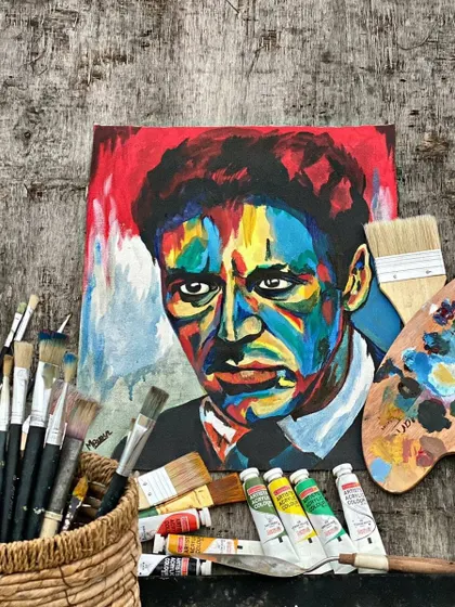 The finished Al Pacino painting, displayed with the tools used to create it. This shows the journey from scattered paints to a cohesive, powerful image.
