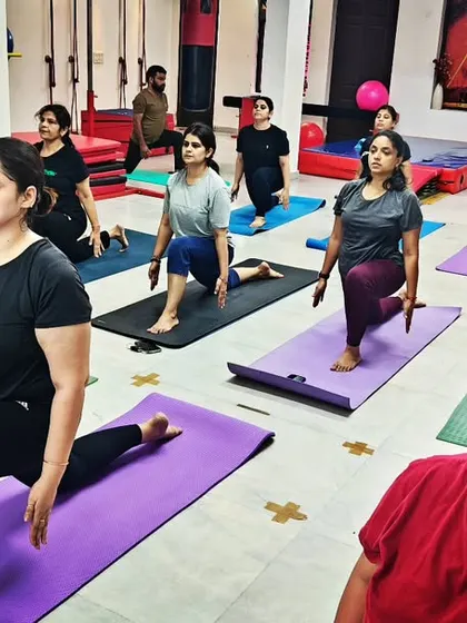 Yoga heals the soul. A powerful image of our group class in Ashwa Sanchalanasana (Equestrian Pose), a posture that builds strength and focus.