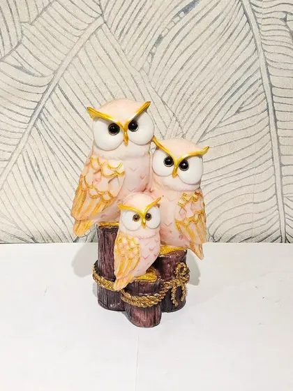 A lovely pink and gold owl family showpiece. The soft colors make it a perfect decorative item for a nursery or a pastel-themed room.