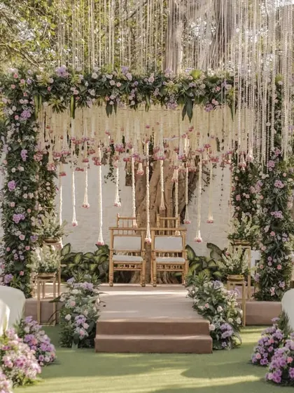A mandap should feel like a sanctuary. For this outdoor wedding, we designed a breathtaking floral mandap with cascading white and lilac flowers, creating a serene and romantic atmosphere for the couple to exchange their vows.