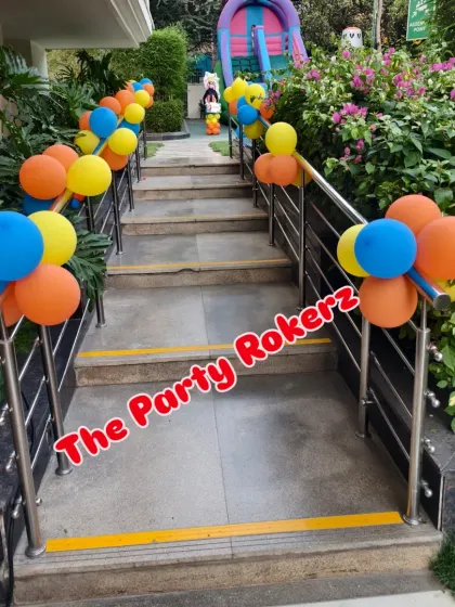 The walkway to the Naruto party, decorated with balloon bunches on the railings, leading guests to the main event area.