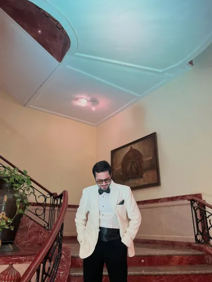A classic look in an elegant white tuxedo, perfect for a black-tie reception or a sophisticated engagement party.