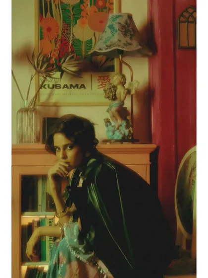 A full-body shot from "Visitors of the past." The leather jacket draped over a delicate, embellished outfit symbolizes a protective layer built against the vulnerability of memory.