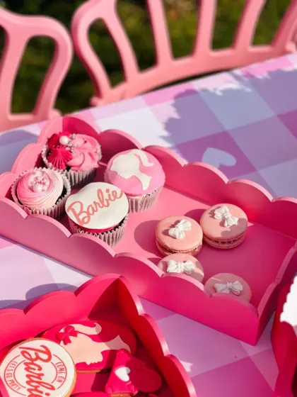 Pink macarons and cupcakes with delicate bow details, perfectly capturing the girly and chic Barbie aesthetic.