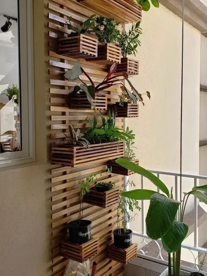 This custom vertical planter stand, made from solid pinewood, is a stylish and space-efficient way to create a plant wall on a narrow balcony. The modular design can be customized to fit any space.