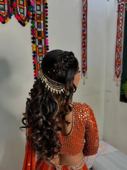 A side view of the beautiful half-up, half-down hairstyle, perfect for an engagement ceremony.