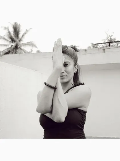 Finding stillness in the arms of Garudasana, or Eagle Pose. This simple wrap of the arms stretches the shoulders and upper back, but it's also a reminder to slow down, focus, and breathe. This is the essence of connecting mind and body in our practice.