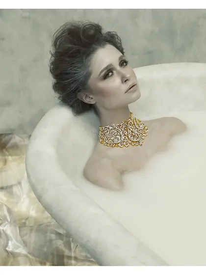 This image is from my "Sculptured Portraits" series, where I explore the intersection of art and photography. The concept was to treat the subject like a classical sculpture, using the milky bath to create texture and the exquisite jewelry as the focal point. It's about creating a timeless piece of art.