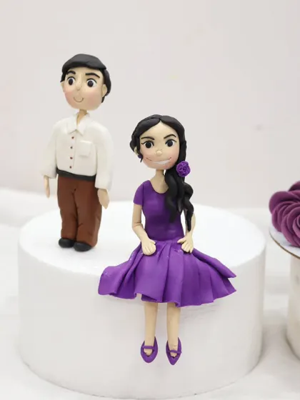 Detailed fondant couple figurines created by a student. I teach how to sculpt faces, create clothing with realistic folds, and style hair to personalize your cake toppers.