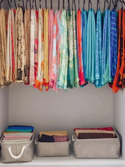 Even in a wardrobe for sarees, the space below the hanging rod can be used for folded blouses, petticoats, or other accessories stored in neat bins.