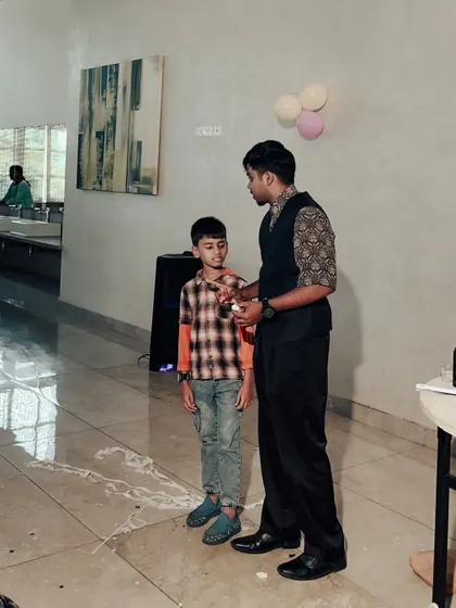A young boy is amazed by a trick during his birthday party. I perform close up magic that happens right in front of the kids, making it a truly personal experience.
