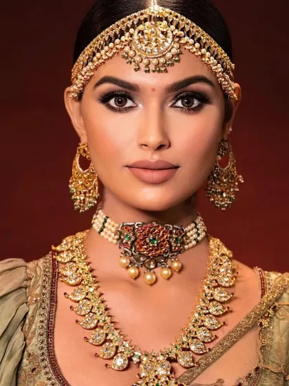 A close-up of a South Indian bridal look. The focus is on creating a flawless, matte base and a sharp, defined eye, which are hallmarks of this traditional style.