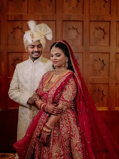 A regal bride in her magnificent red lehenga. We capture the grandeur of the bridal attire, creating portraits that are both powerful and elegant.