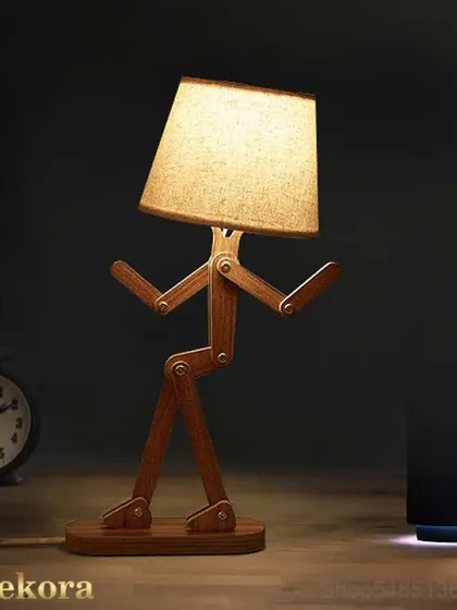 Our articulated wooden robot lamp, a fun and functional piece of decor. The adjustable limbs allow you to pose it in different ways, adding a dynamic element to your space.