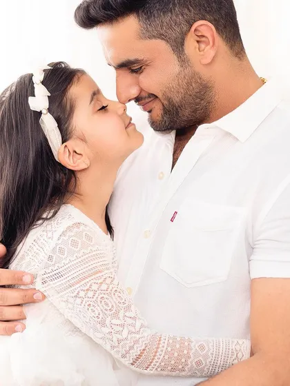 The special connection between a father and his daughter. This close-up, nose-to-nose shot is full of love and tenderness.