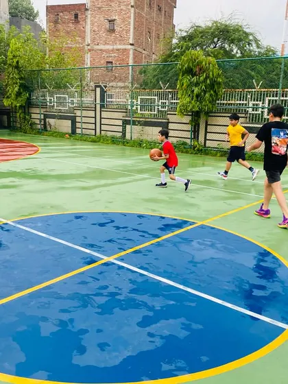 A junior player dribbles through a puddle, learning to control the ball in all conditions.