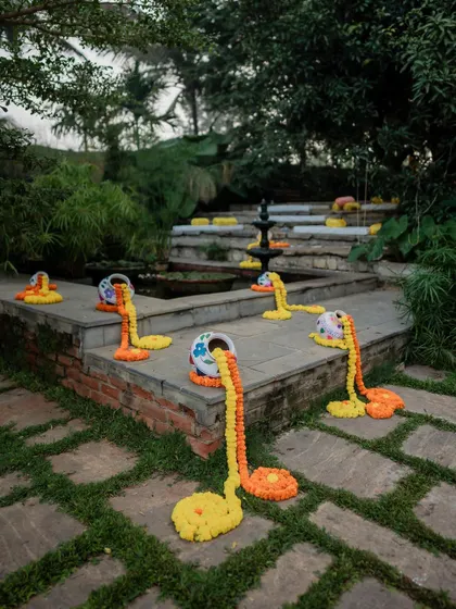The charming and rustic decor of a traditional Haldi ceremony, with marigold garlands adding a splash of vibrant color.