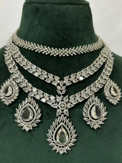 A close-up of a layered American diamond necklace, showing the intricate leaf-like patterns. This is a beautiful rental piece for any special occasion.