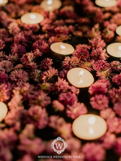 Simple yet elegant details like these chair ribbons and floral arrangements can transform a space. For this reception, we used purple florals and lanterns to create a romantic ambiance.