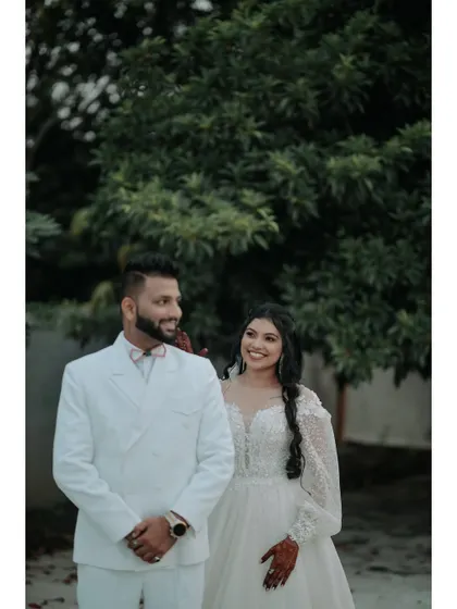 A candid moment of happiness. The couple shares a smile, their joy evident in this natural and relaxed portrait from their engagement day.