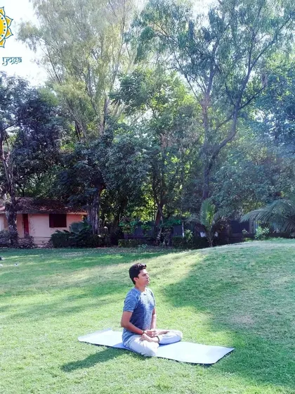 Seated in a meditative posture in a peaceful park. A sound body is the foundation for a sound mind. My practice aims to bring you to a state of perfect health, so your mind is free to explore deeper states of consciousness.