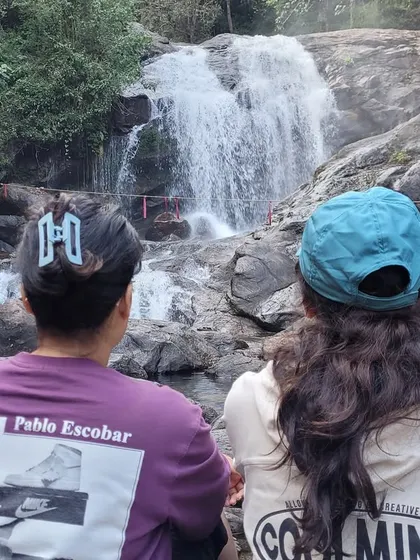 Taking a break to admire the beautiful Lakkom waterfalls, a refreshing stop during our Munnar sightseeing.