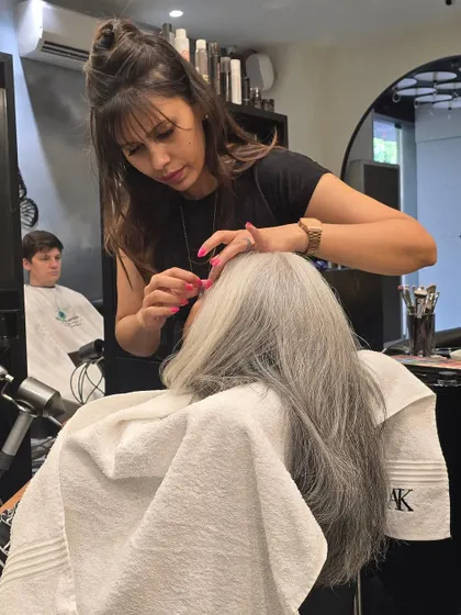 Our artist focused on perfecting the eye makeup for a client's cocktail party look, demonstrating our commitment to detail.