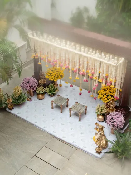The entire venue becomes a part of the story. Here, hanging floral decorations in the courtyard create a beautiful rhythm, echoing the traditional architecture and filling the space with color and life.