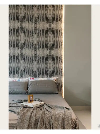 A close-up detail of the bedside, showing the texture of the wallpaper and the soft, diffused light from the integrated LED strips, which create a relaxing ambiance.