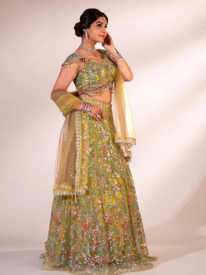 A full-length shot of the lime green lehenga. The vibrant color and all-over embroidery make it a truly festive and eye-catching piece.