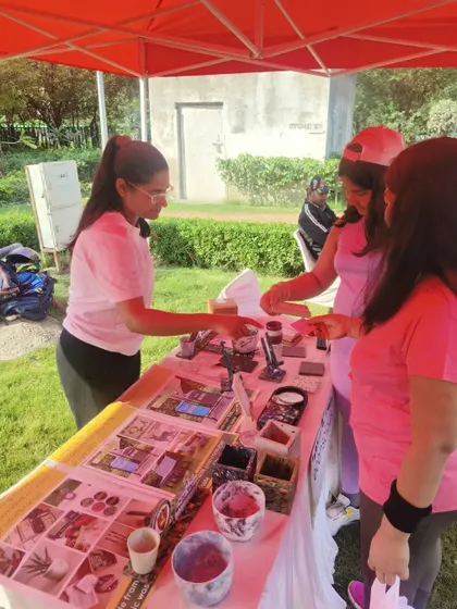 Our co-founder Sonal interacting with visitors at an outdoor event. It's always rewarding to see people's curiosity and excitement when they learn our products are made from waste.