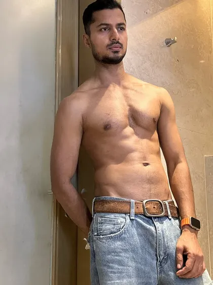 A casual, shirtless look in jeans. This demonstrates a natural, healthy physique that's relatable and aspirational for lifestyle and fashion brands.