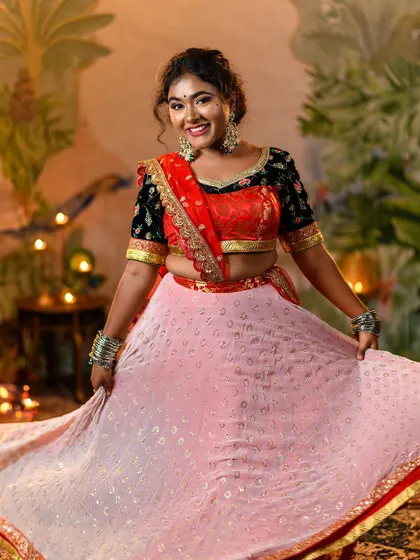 A bright, smiling portrait that captures the charm of Leela. This shot gives a clear view of the outfit's details, including the silver bangles and the intricate blouse embroidery.