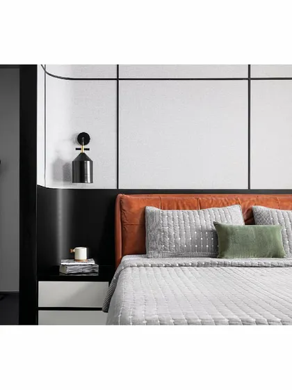 In the 'Reflections' project, the master bedroom features a striking tan leather bed. The color provides a warm contrast to the stark black, white, and grey palette of the room, creating a focal point that is both bold and inviting.