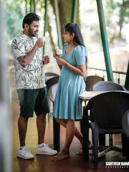 A relaxed lifestyle shot of a couple sharing coffee and conversation at an outdoor cafe.
