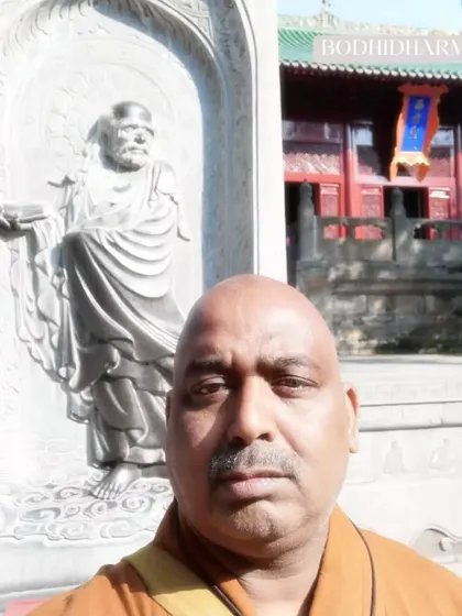 A self-portrait with the statue of Bodhidharma, or Damo. He is the foundation of our Zen and martial arts practice, and I draw inspiration from his legacy.