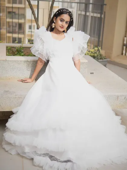 Another view of the white ruffle sleeve gown, showing its unique silhouette and dreamy design.