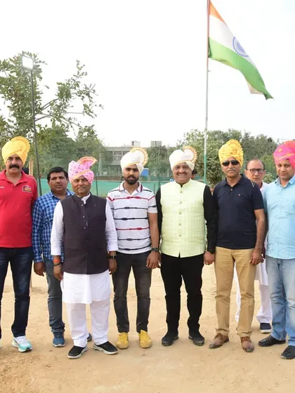Honored guests, including coaches and federation officials, standing with me under the Indian flag at our academy tournament.